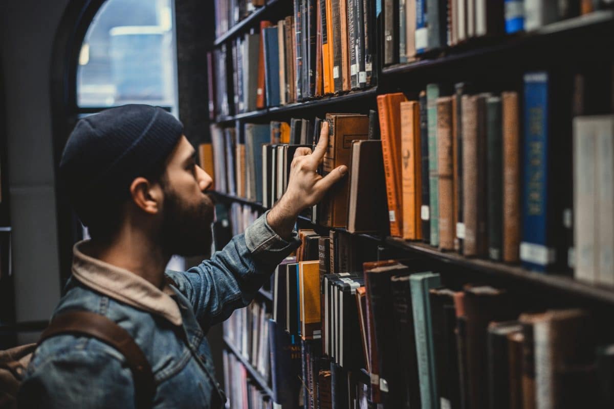 Man picking book