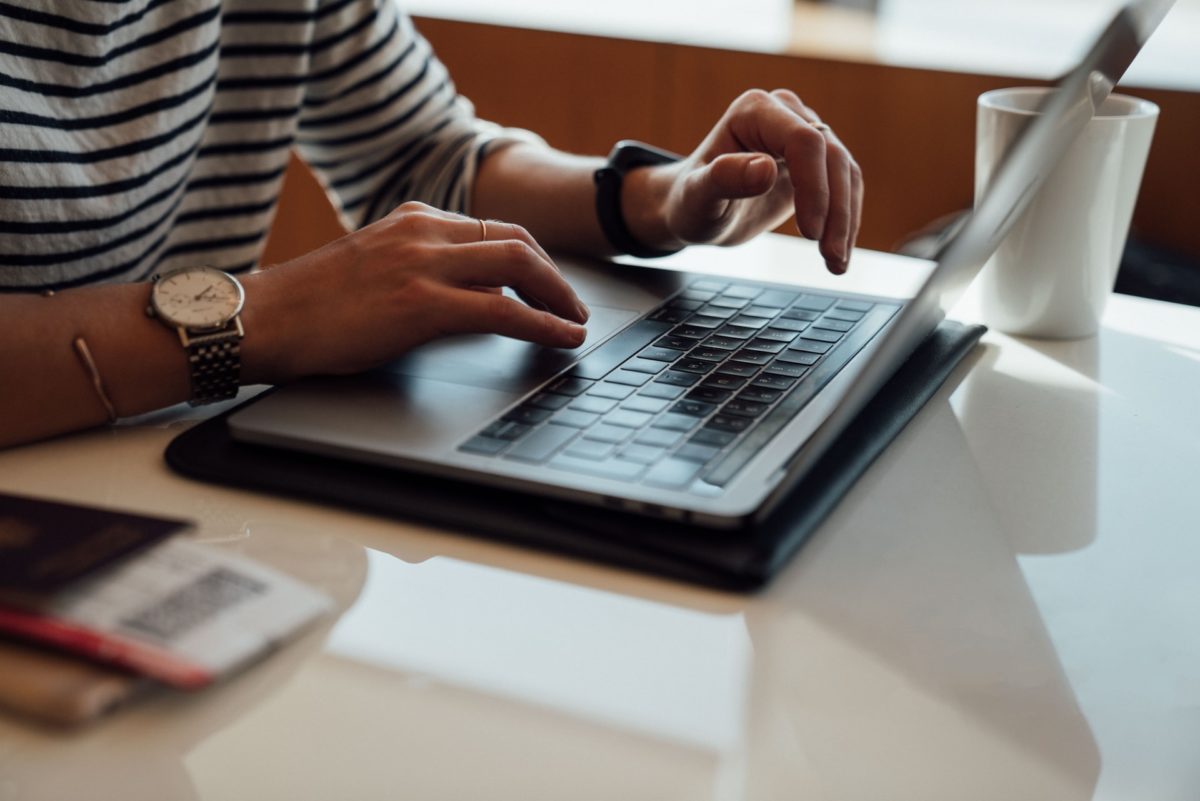 Events signup. Person typing on laptop.