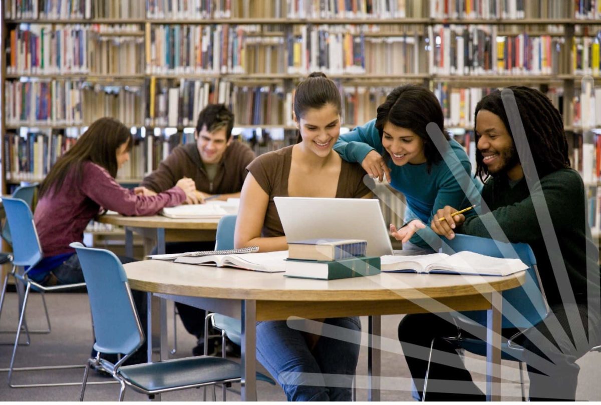 Access Lab program. Group of people looking at a laptop in a library