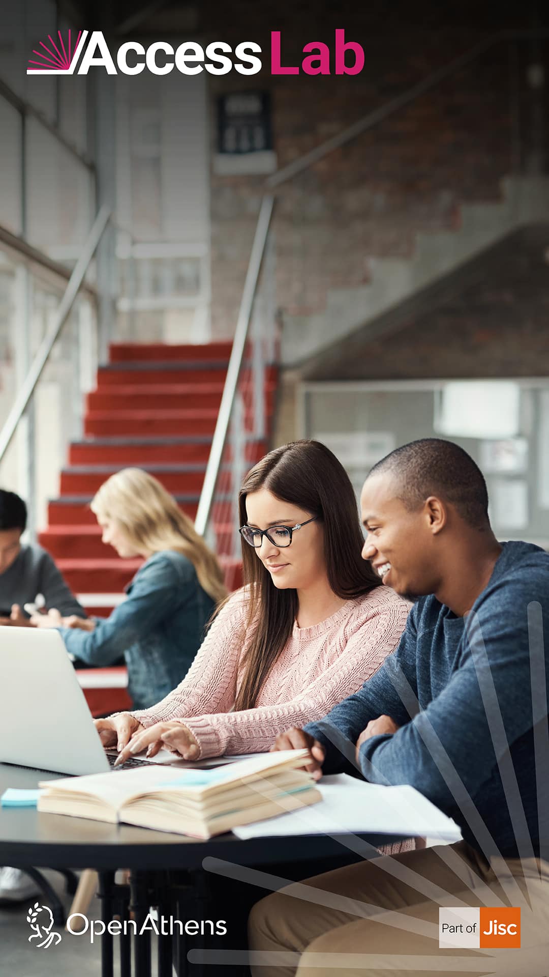 Two people sat looking at a laptop doing research